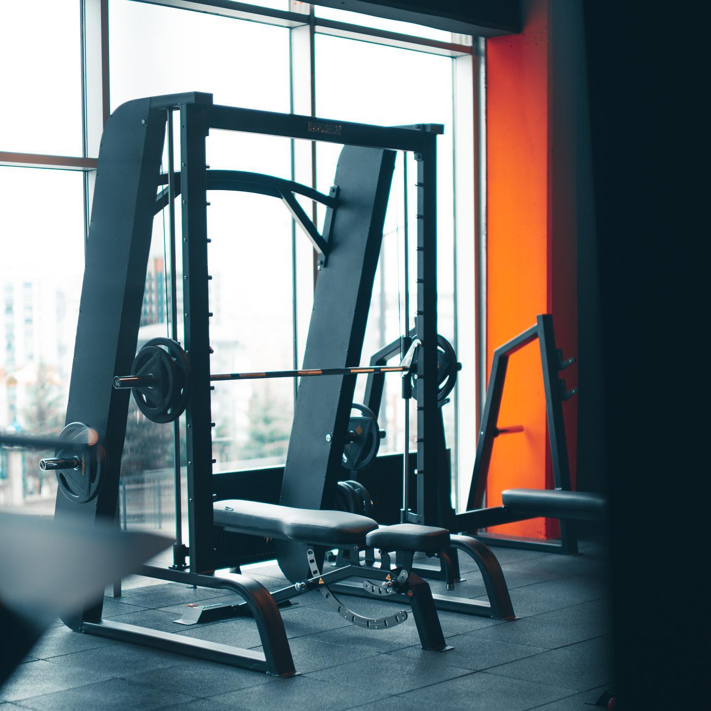 Modern weight training area with free weights and benches